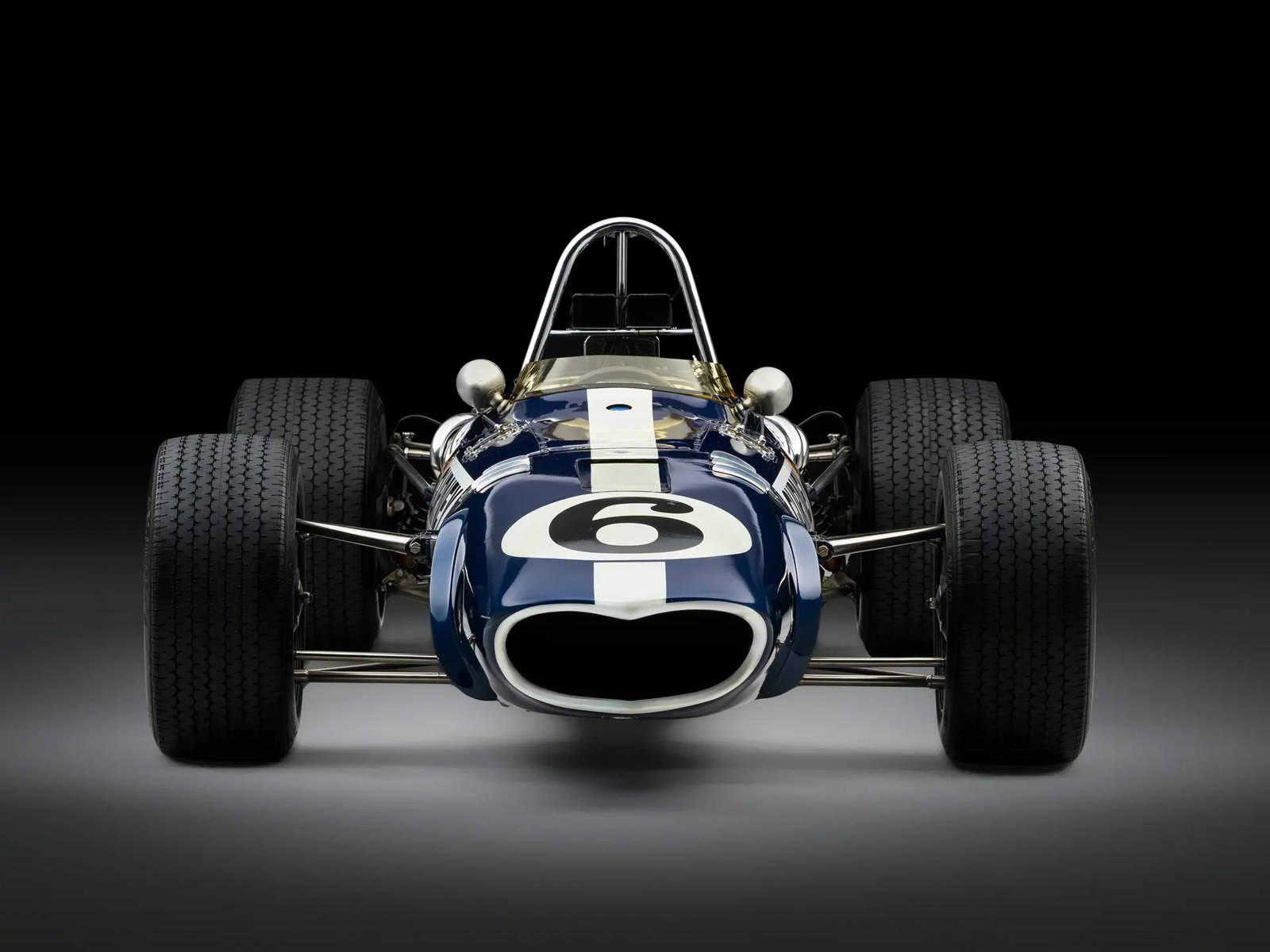 The beak. The Eagle's nose is the reason the car gets called the most beautiful Formula 1 machine ever built about as often as it gets called the most frustrating, and the reversed American racing colours — blue with a white stripe — are how AAR ran it.