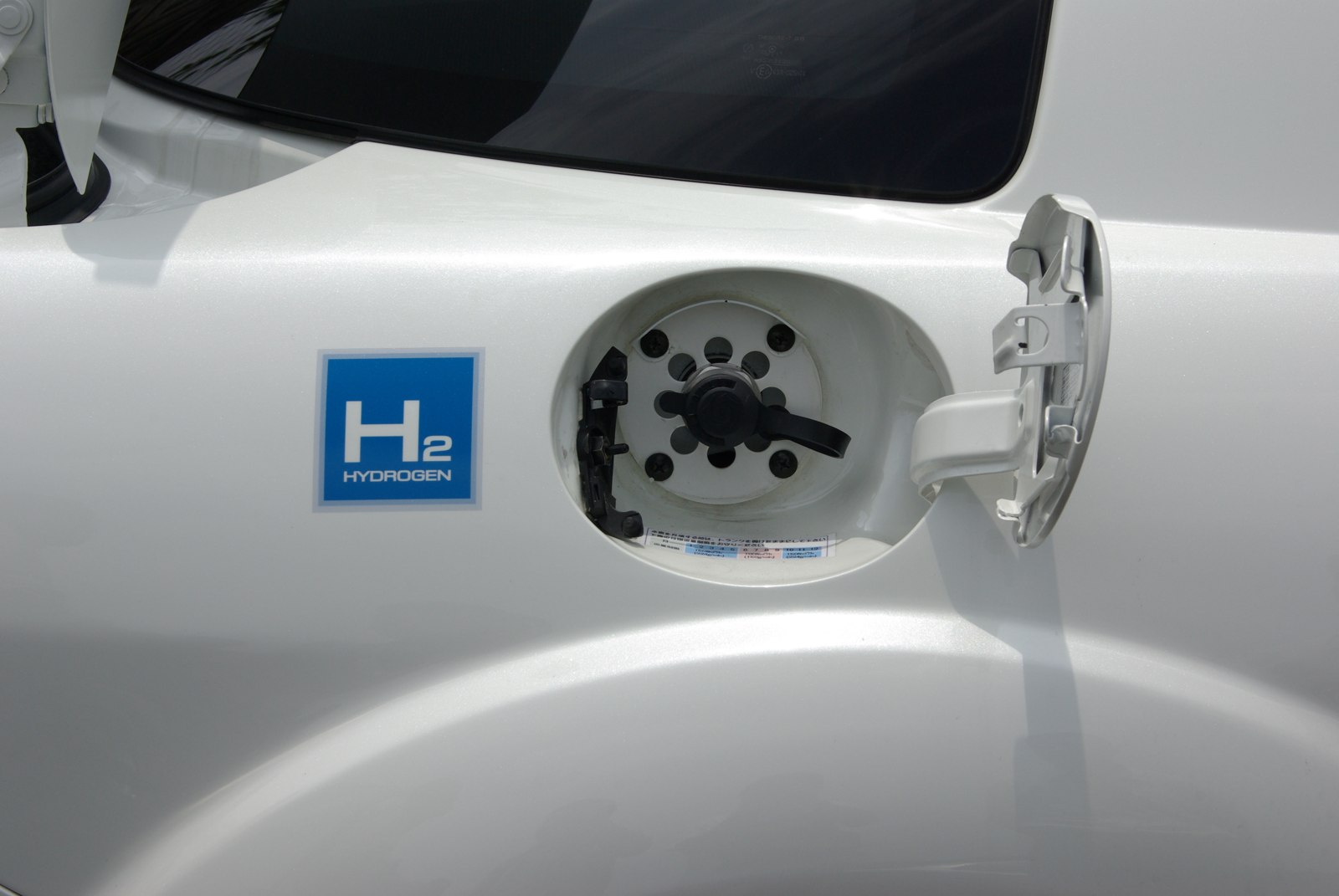 The RX-8 Hydrogen RE's fuel port — H2 on one side, gasoline filler underneath.