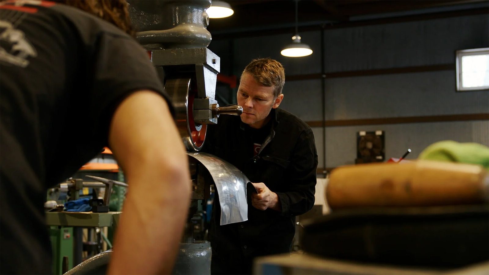 Chris Runge, a self-taught metalsmith who has been hand-forming aluminum-bodied sports cars out of his rural Alexandria, Minnesota shop since 2011, oversees the workshop.